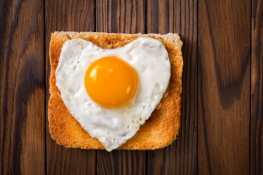 heart shaped cooked egg on a slice of toast