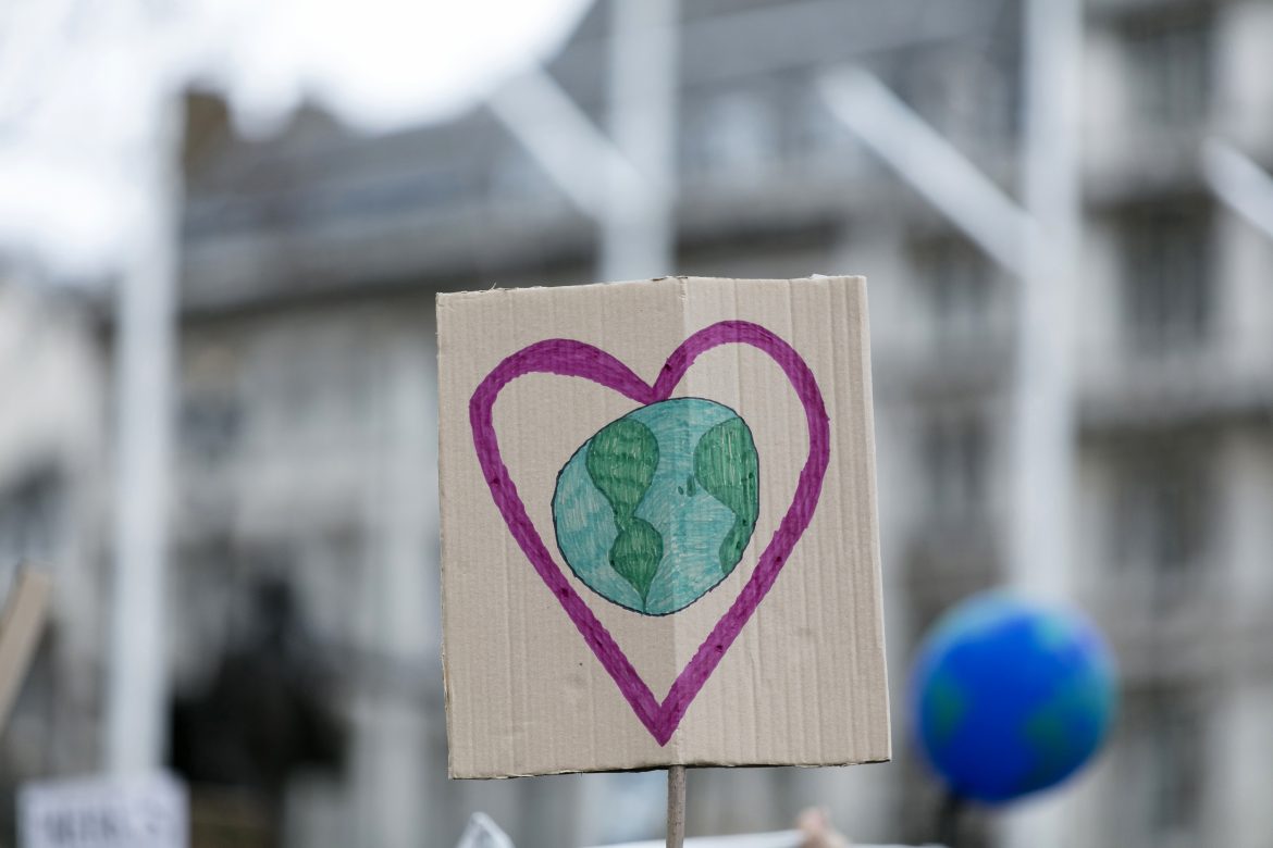 People with banners protest as part of a climate change march