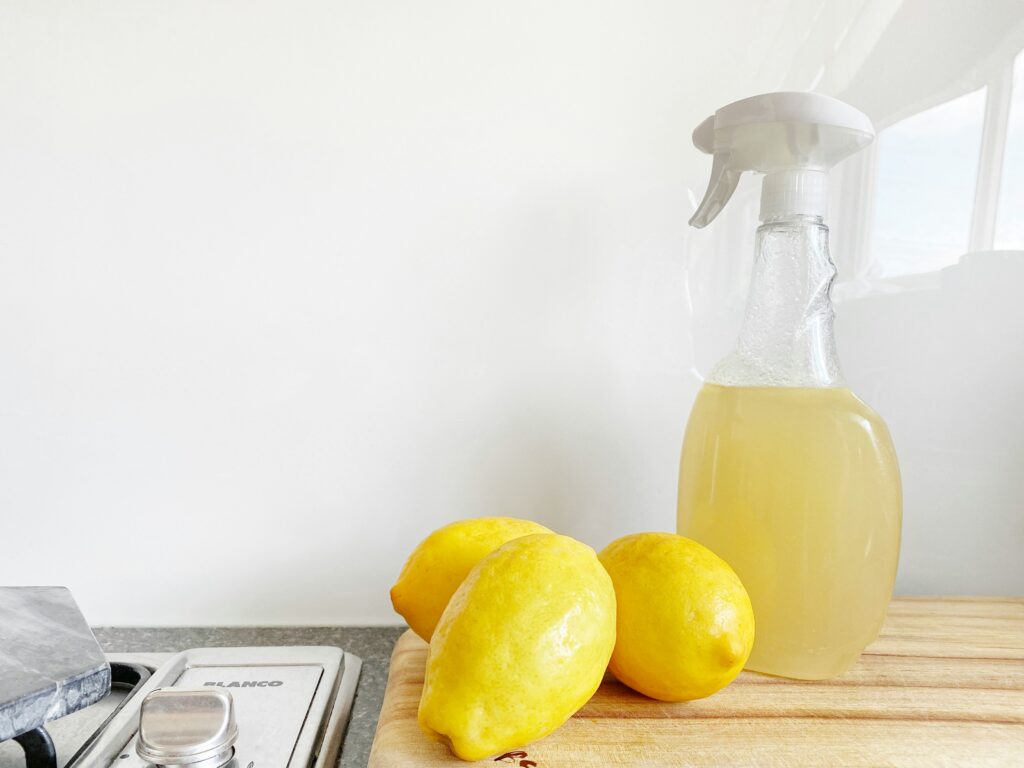 Countertop with lemons and bottle of homemade cleaner