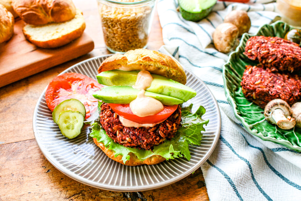 Dinner table with a plate showcasing a plant-based burger and the ingredients used to make it