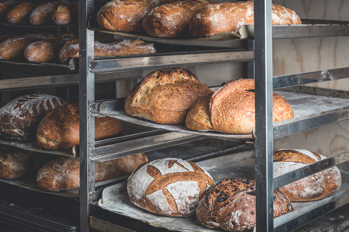 Baker's rack of freshly baked loaves of bread